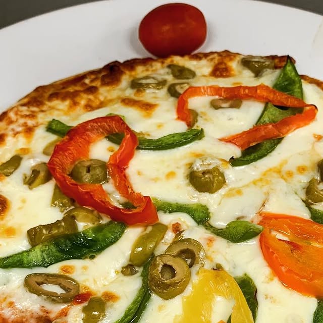 Personal thin crust pizza with peppers, olives, and tomatoes